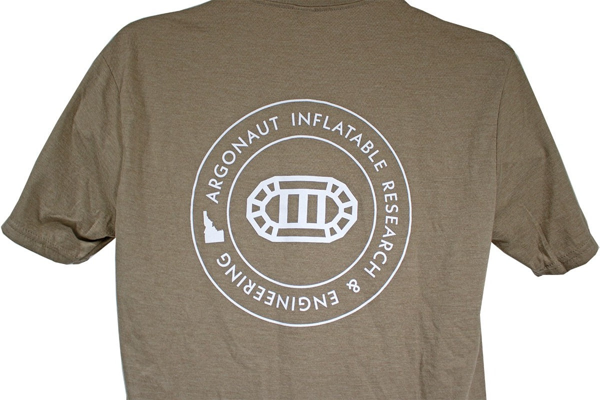 Close-up of the Argonaut Inflatable Research & Engineering seal with Idaho outline and raft on the brown AIRE T-shirt
